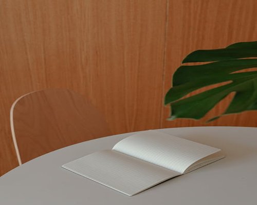 Neat workspace with balanced lighting and analog notebook