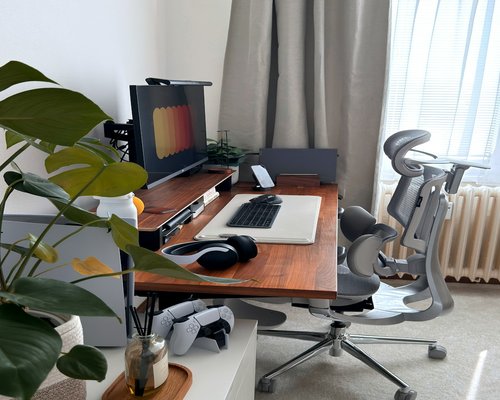 Well-lit office desk setup with ergonomic chair