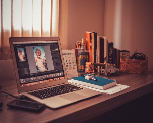 Cozy home office with warm desk lamp and notebook